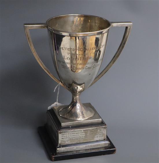 A George V silver two handled trophy cup, Glasgow, 1913, on ebonised base,